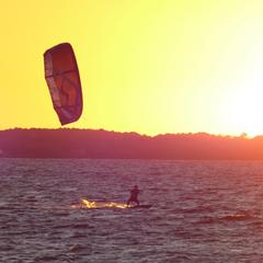 Kiter silhouetted by setting sun